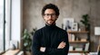 © LIA - Portrait of a confident man with glasses standing with arms crossed in a modern home office