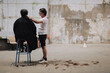 © Luciano Spinelli/Stocksy - Barber Cuts Hair in an Empty loft studio