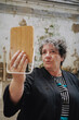 © Luciano Spinelli/Stocksy - Portrait Woman Holding Wooden Mirror