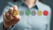 © Dream Studio - Person holding physical smiley face icon sticker representing satisfaction levels choice among multiple colorful emotional faces for customer feedback surveys and quality assessment process.