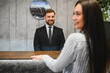 © Serhii - Hotel reception welcoming guest with professional service