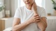 © SunSpirit - An older woman scratching itchy skin on her arm and neck.