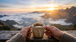 © ENDI - Serene mountain sunrise with a steaming coffee cup held by two hands overlooking a misty valley landscape
