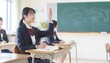 © 誠 小野 - 教室で手を挙げて授業に参加する女子高校生