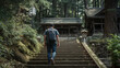 © bephoto - 初夏の森の神社で石段を上る男性の参拝旅