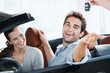 © peopleimages.com - Couple, excited and smile with keys, car dealership and appointment for purchase and celebration. Loan approval, showroom and people shopping for vehicle, rental or investment for transportation