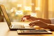© Buckley - Hands typing on laptop with glowing email icons