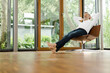© Westend61 - Man relaxing on chair in his living room