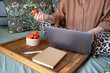 © Ina - Woman using laptop while sitting comfortably in bed with strawberries and notebook nearby. Remote work, freelance activity, online communication and flexible home office lifestyle concept.