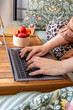 © Ina - Woman working on laptop at home while sitting comfortably in bed with fresh strawberries nearby. Remote work, freelance lifestyle, healthy snack and flexible workspace concept in cozy interior.