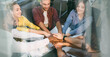 © Prostock-studio - Happy Diverse Group Of Young Adults, Including Male And Female Individuals, Collaborating By Stacking Hands Together At Office Workspace, Showing Team Spirit. Business Concept.