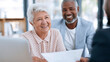 © DR Moura - Diverse senior couple smiling during a financial consultation with an advisor
