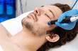 © wedmoments.stock - Male patient receiving professional facial cleansing and hydration with HydraFacial technology. Concept aesthetic care, healthy skin and cosmetology.