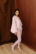 © Tania Cervian/Stocksy - Elegant woman posing in pastel fashion outfit