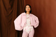 © Tania Cervian/Stocksy - Woman in pink jacket and floral bodysuit