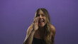 © Krakenimages.com - Woman cups hand to mouth calling to camera, bare shoulder visible wearing strapless top in studio with purple backdrop and smiling expression; joyful connection.