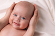 © Tina kids photo - portrait of a baby, the mother strokes the baby's head and smiles