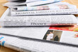 © Pixel-Shot - Stack of newspapers with finance headline and images