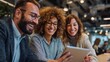 © Muntazim - Three diverse friends, including a Caucasian man, a Middle-Eastern woman, and a Hispanic woman, enjoy a moment together viewing a tablet.