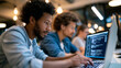 © Nataliya - Multiethnic group of faceless young professionals collaborating around laptops in modern office discussing software development project, tech teamwork concept, coding team