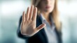 © Fun Factory - Professional business woman, businesswoman wearing a dark blazer extends her hand forward in a clear gesture to stop or block unwanted actions while working inside an office, showing rejection