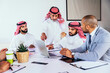 © Westend61 - Business team discussing strategy with laptop in Riyadh office