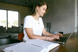 © Westend61 - Freelancer working on laptop sitting at home office