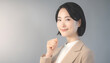 © noonekoon - Determined young asian businesswoman making a fist gesture for motivation ガッツポーズで意気込むスーツ姿の若いアジア人ビジネス女性