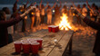 © Iryna - Friends cheering with drinks at a lively beach party bonfire with a beer pong game, celebration and festive social gathering at night.