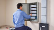 © Jakub - Technician repairing fuse box