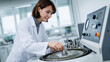 © lamia - Young female scientist in white lab coat working with medical centrifuge machine in modern research laboratory