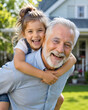 © Andres Mejia - Happy grandfather giving piggyback ride to granddaughter outdoors