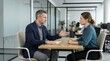 © Sofia - Professional businessman giving advice to a female colleague in a modern office. Business meeting and consulting concept