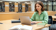 © Alexandr Peers - University student preparing academic research paper or studying for exam using computer in library, higher education coursework and information science textbook literacy on table