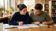 © Alva - Two focused university students collaborate on their studies, writing notes and discussing assignments at a wooden table in a well-lit library.