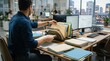© palm - Professional male employee organizing project file folders on desk in modern corporate office workspace at sunset