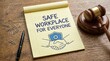 © Mudassir - Yellow notepad with safe workplace for everyone written on it next to a wooden gavel