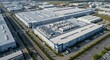 © YLing - Expansive modern manufacturing complex with extensive rooftop industrial equipment seen from an aerial perspective