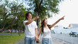 © blueringmedia - Young Asian Couple Pointing at Landmarks While Walking in Thailand