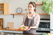 © buritora - A housewife preparing a one-plate lunch in the kitchen.