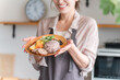 © buritora - A housewife having a one-plate lunch in the kitchen