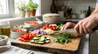 © Wawan - Man chopping fresh vegetables on a wooden cutting board in a home kitchen with chopping vegetables preparation culinary homemade nutrition ingredients tomatoes zucchini