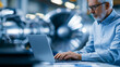 © Laura - Faceless senior chief engineer using a laptop, analyzing and researching how a futuristic turbofan motor works, senior manager developing innovative technology in a high-tech