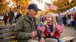 © KAMJALIYARAMDEV - Senior military veteran and young girl holding American flags on a park bench. Happy grandfather and granddaughter celebrating Veterans Day outdoors in autumn