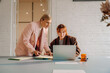 © DZ FILM/Stocksy - A woman uses a laptop in the office
