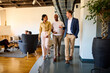 © Ivan Jovanovic/Stocksy - Colleagues walk through corporate environment