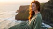© ArtDreams92 - Portrait of a beautiful young redhead woman standing on windy coastal cliffs