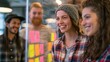 © Up - Diverse young creative agency team brainstorming with colorful sticky notes on glass wall