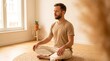 © Hypnyo - Man meditating in lotus position on woven rug in bright minimalist living room for mental health and mindfulness wellness content.