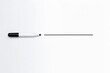 © Fotograf - A black pen rests on a clean white surface, ready for use